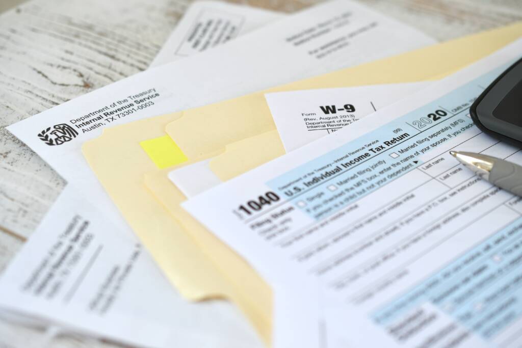 calculator and receipts on a desk for self-employed 1099 tax deductions in Texas