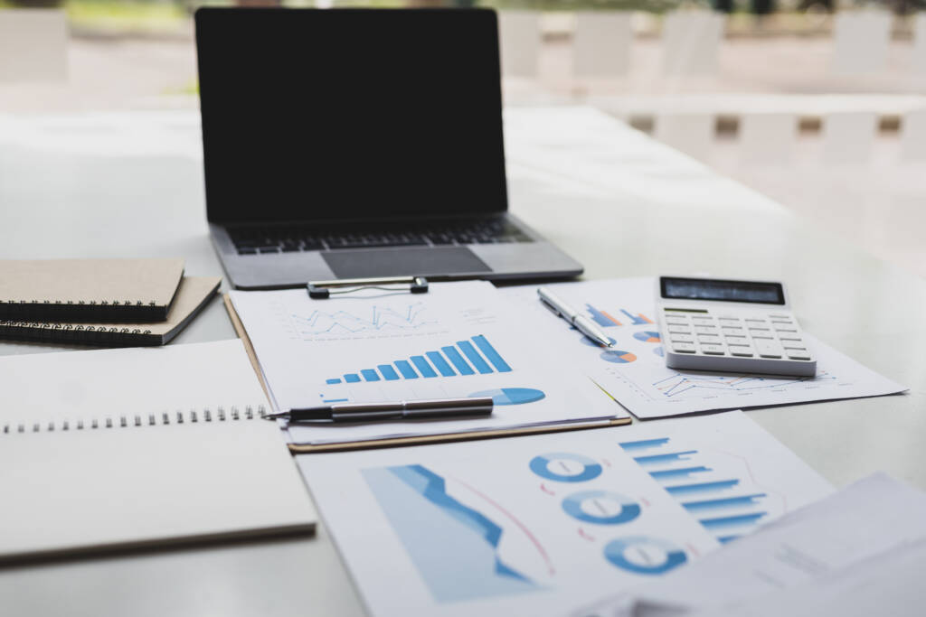 financial records and calculator on a desk for small business bookkeeping in Texas