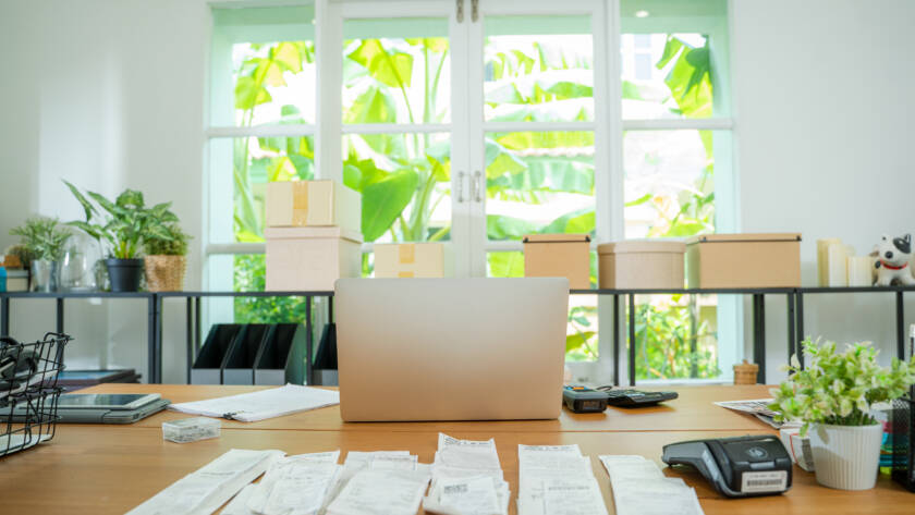 organized bookkeeping records and laptop on a desk for small business owners in San Antonio Texas