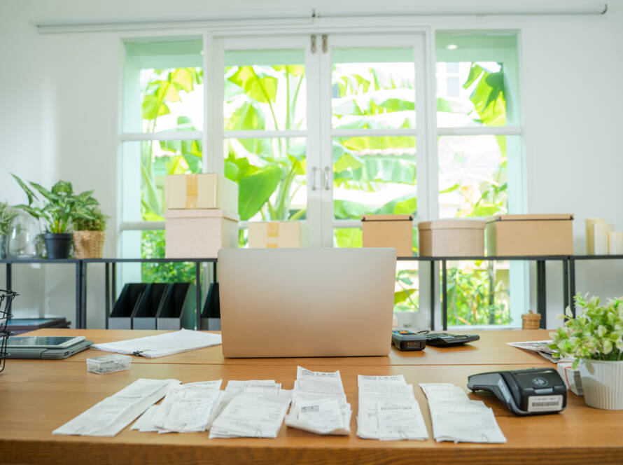 organized bookkeeping records and laptop on a desk for small business owners in San Antonio Texas